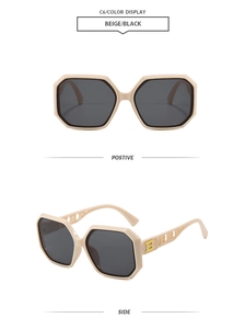 Detail view of beige geometric sunglasses with golden B logo and hollowed-out temples