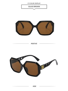 Detailed view of the gold letter B logo on retro oversized polygon sunglasses temples