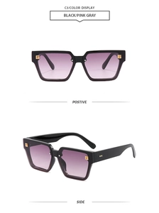 Detail view of square black sunglasses with gradient lenses and gold G metal logo