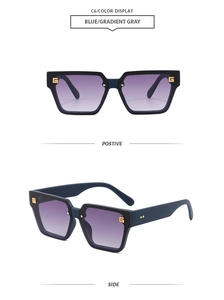 Detail view of square oversized blue sunglasses with gold metal hinges and gradient lenses