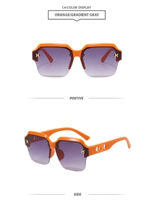 Detail of orange semi-rimless sunglasses with gold H hardware and gradient grey lenses