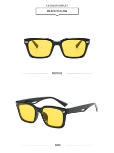 Detail view of black square sunglasses with yellow lenses and hollowed temple design