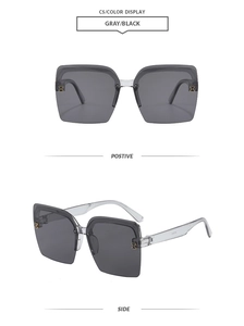Detail of the golden H metal logo on the side of grey rimless square sunglasses