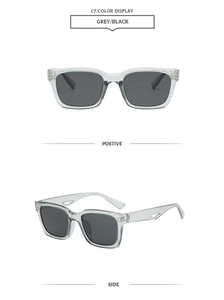 Detail view of transparent grey rectangular sunglasses with side metal accent and hollow temple