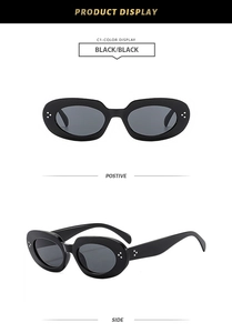 Detail view of oval black sunglasses featuring stylish silver rivets and dark grey lenses