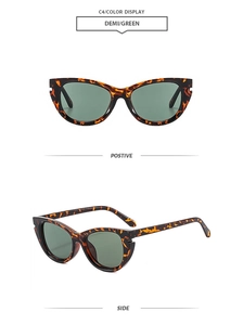 Detail view of demi frame cat-eye sunglasses with green lenses and cutout design