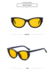 Detail view of cat-eye sunglasses with black frames, yellow lenses and blue temples