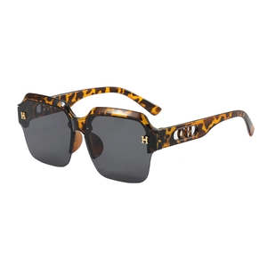 Chic tortoiseshell oversized square sunglasses with gold metal H logo on white background