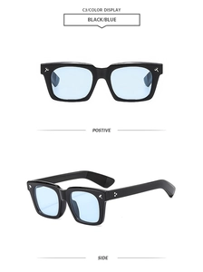 Detail of square oversized sunglasses with black frame and light blue tinted lenses
