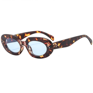 Retro oval tortoiseshell sunglasses with light blue lenses and rivet details on white