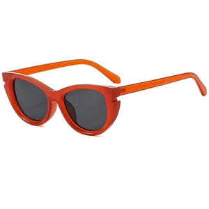 Retro cat-eye sunglasses with translucent orange frame and dark grey UV lenses for outdoor