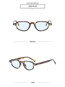 Detail view of tortoiseshell cat-eye sunglasses with blue lenses and metal hinges