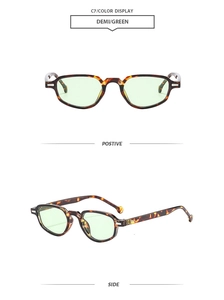 Detail view of cat eye sunglasses in demi frame with green lenses and metal hinges
