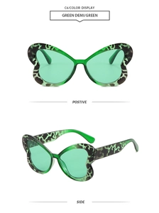 Vues de face et de profil de lunettes de soleil papillon surdimensionnées en écaille verte