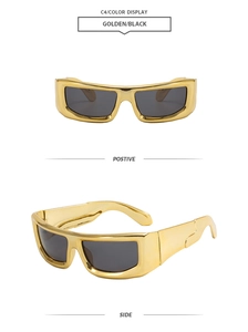Close-up of futuristic wide gold frame sunglasses with deep black lenses and thick temples