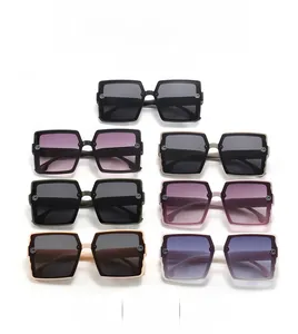 Detailed view of square sunglasses featuring wavy edges and a golden G logo on the temple