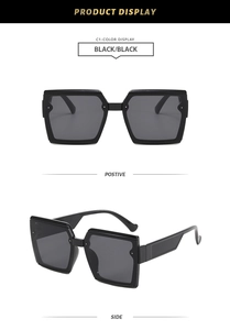 Macro display of retro oversized square sunglasses with black frames and sleek temples