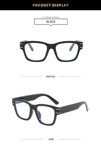 Detail of black thick frame square glasses with gold metal accents on side temples