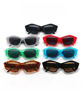 Flat lay of seven stylish cat eye sunglasses in various colors on white backdrop