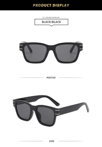 Detail view of large square black sunglasses featuring elegant gold temple accents