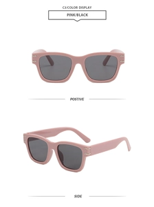 Detail view of pink square frame sunglasses with dark lenses and gold decorative bars