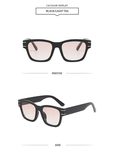 Detail of square black sunglasses frame featuring golden metal bars and gradient tea lenses