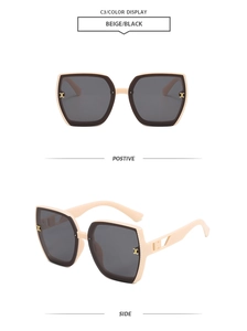 Detail view of beige polygon sunglasses featuring gold C-logo on the frame and dark lenses