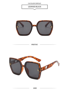Detail view of leopard print sunglasses with black round lenses and gold accents