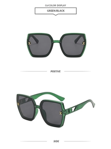 Detail view of vintage polygonal sunglasses featuring green frames and gold H-logo accents
