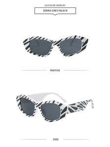 Detail view of irregular cat eye zebra print sunglasses in positive and side angles