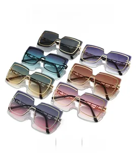 Close-up of rimless oversized square sunglasses in multiple gradient colors and metal frames
