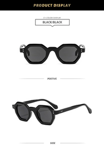 Detail view of black polygonal sunglasses featuring metal rivet accents and dark lenses