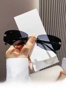 Detail of rimless polygon sunglasses with dark lenses and metallic silver nose bridge
