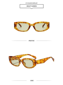 Detail view of tortoiseshell cat-eye sunglasses with thick frames and green lenses