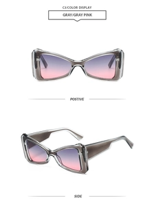 Detail view of triangular cat-eye sunglasses with transparent gray frames and gradient lenses