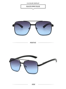 Detail of vintage metal double-bridge pilot sunglasses with grey-blue gradient lenses