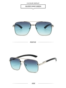 Close-up of silver metal pilot sunglasses with gray green gradient lenses and black temples