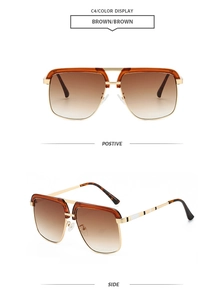 Detail of double bridge sunglasses featuring gold metal frame and brown gradient lenses