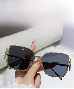 Close-up of golden frame sunglasses featuring luxury rhinestone star decorations