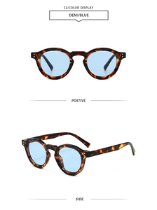 Detail view of round demi tortoise frame sunglasses with light blue lenses and metal rivets