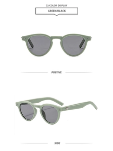 Detail view of round sage green sunglasses with black lenses and star metal accents