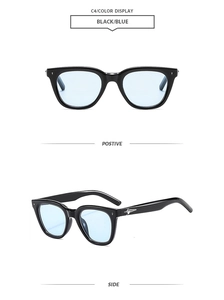 Detail of black frame sunglasses with light blue lenses and silver star accents