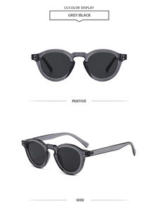 Detail of retro round sunglasses in translucent grey with silver metal studs