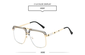 Side view of oversized gold and gray sunglasses with detailed temple accents