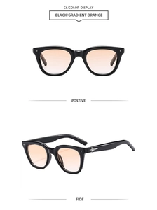Detail view of black polygon sunglasses featuring orange gradient lenses and star accents
