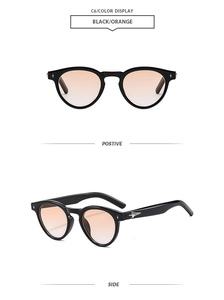 Close-up of black round sunglasses with orange gradient lenses and star-shaped metal accents