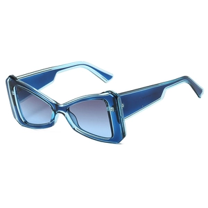 Fashionable triangle cat eye sunglasses with blue gradient lenses and thick blue frames