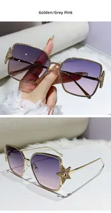 Close-up of golden metal frame sunglasses with crystal star detail and purple gradient lens