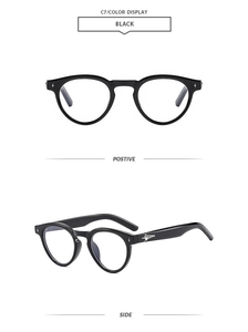 Detail view of black round sunglasses featuring silver star ornaments on the side temples