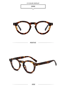 Close-up of tortoise shell round sunglasses with vintage metal rivet details